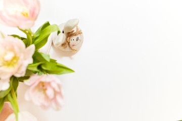 bouquet of tulips and Easter bunny on white table. copy space