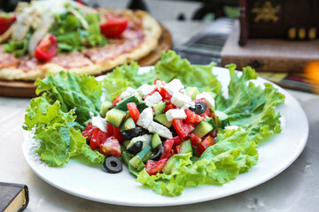 Fresh Salad and Pizza on a White Plate