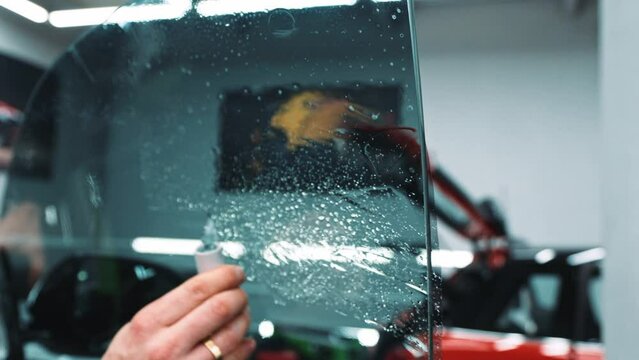 Car window film installation service in the showroom, cars concept . High quality 4k footage