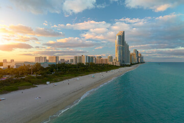 View from above of luxurious highrise hotels and condos on Atlantic ocean shore in Sunny Isles Beach city in the evening. American tourism infrastructure in southern Florida
