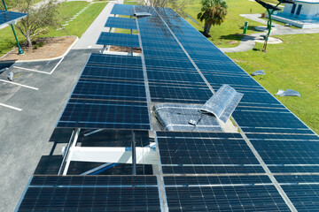 Wind damage to solar panels installed over parking lot canopy shade for parked cars for effective...