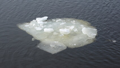 An ice floe floats on a spring river