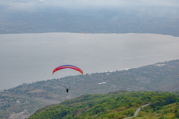 Paragliding soars at salena peak, palu city, Central sulawesi.