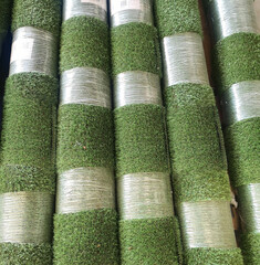Rolls of artificial turf stacked for sale