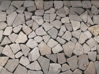 High-resolution image showcasing an assortment of irregular stone blocks used in paving