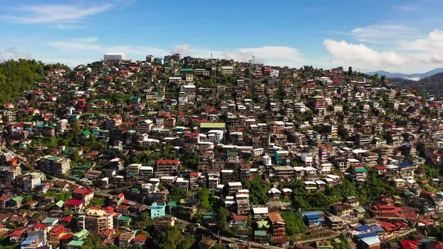 Top view of colorful buildings and houses hug the mountainous hills of Baguio City. Philippines, Luzon.