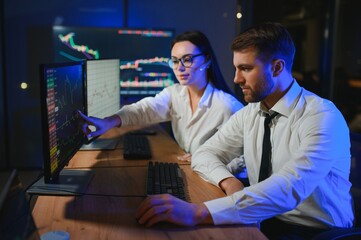 Business team investment working with computer, planning and analyzing graph stock market trading with stock chart data