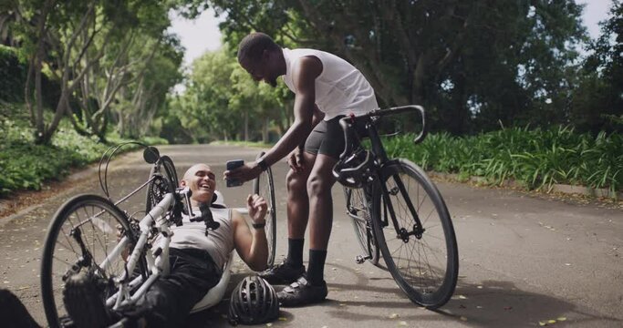 Sports, cycling and men with phone on bicycle in park for training, cardio workout and exercise. Person with disability, paralympic and friends on smartphone for competition, challenge and fitness