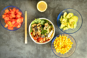 Fresh vegetarian salad bowl with ingredients on side