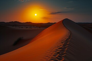 Stunning sunset over desert dunes with vibrant orange sky and contrasting shadows on sand.