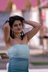 Fototapeta premium A woman in a blue and white dress is posing for a photo