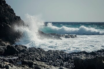 Waves crashing against rocky shore with spray, dynamic ocean scene.