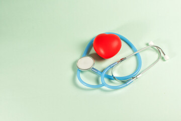 Top view of a stethoscope and red heart, isolated on blank background.
