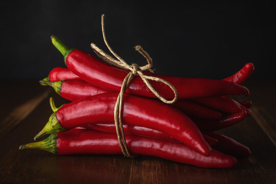 Red Chili Peppers on old wooden background. Food background.