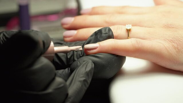 Nail acrylic paint applied onto nail, by nail technician
