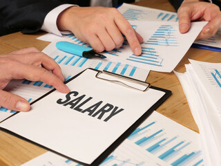 Salary negotiation. Employer shows employee results of the work. Wages money finance business...