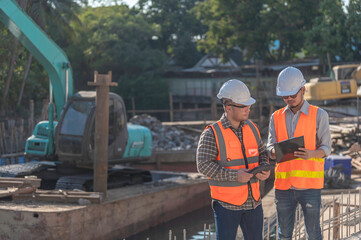 Construction engineer working on a bridge construction site over a river,Civil engineer supervising...