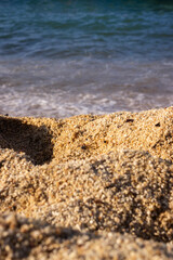 beach sand in the foreground, blue sea in the background, blue horizon, tranquility, serenity, rest,