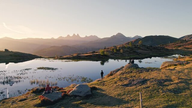 Sunrise shines over Lac Guichard with Arves massif and lake reflection in autumn at Aiguilles d'Arves, French Alps, France