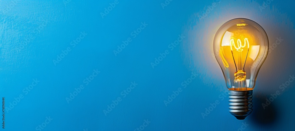 Aufkleber illuminated light bulb on block with empty space for text on plain color background