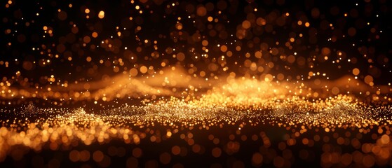   Gold dust on a black background with a blurred image of lights in the foreground