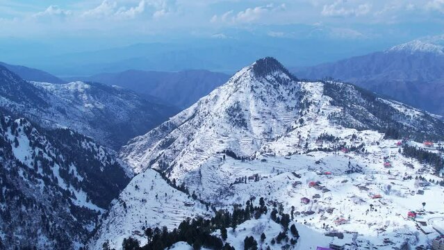Aerial view of Malam Jabba Hill station and Himalayan mountains covered in snow