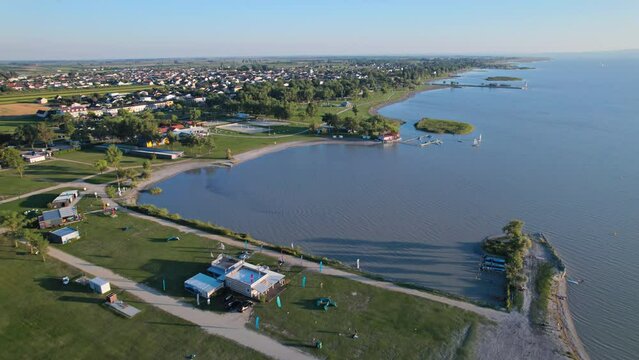 Aerial view of lighthouse and public beach in Podersdorf am See on Lake Neusiedl (Neusiedler See), Burgenland, Austria. 2.5x speeded up from 24 fps.