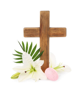 Wooden cross, painted Easter egg, lily flowers and palm leaf on white background