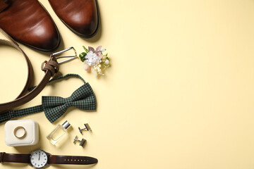 Wedding stuff. Flat lay composition with stylish boutonniere on yellow background, space for text © New Africa