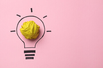 Idea concept. Light bulb made with crumpled paper and drawing on pink background, top view. Space...