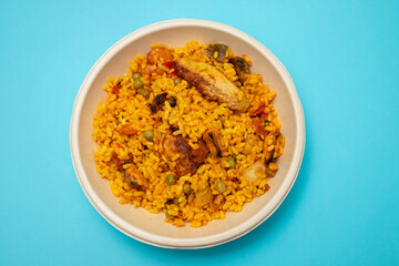 typicla spanish dish paella in plastic plate
