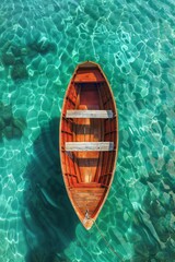 A wooden boat floats gently on the clear, turquoise water. Top view, Wallpaper