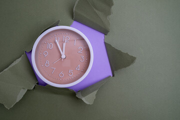 White alarm clock on a colored background. Fashionable minimalist style. Time, business and technology concept. Flat composition. View from above