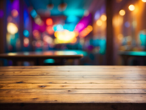 An empty wooden table top with a blurred background design.