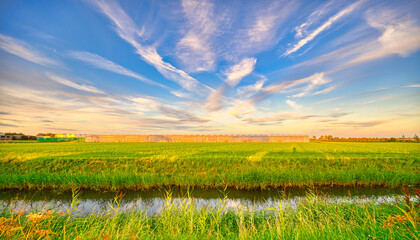 Clouds like rough brush strokes in the sky of rural Holland.