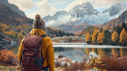 Woman immersed in nature's beauty: contemplating mountain lake amidst autumn forest - serene adventure travel scene