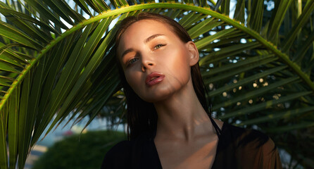 beautiful passion girl in palm leaves. young woman with Make-up under palm tree - 768987228