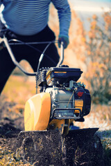plowing the garden with special equipment on a autumn day