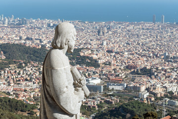 Statue of apostle observing on city Barcelona on Temple Sacred Heart of Jesus on Mount Tibidabo.