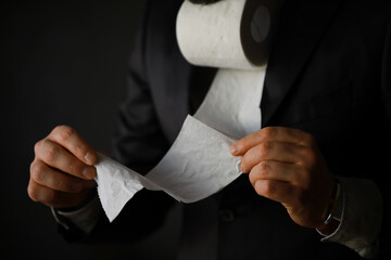 Rich Businessman paying in Toilet Paper, copy space. Toilet papers is the new currency - obrazy, fototapety, plakaty
