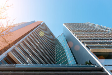 Modern office building with facade of glass on sky background.
