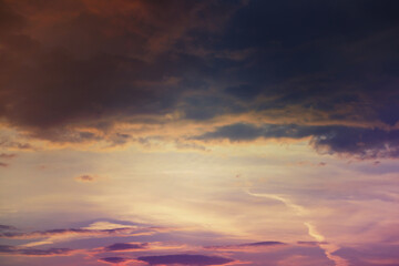 Beautiful sunset sky above clouds with dramatic light. Cabin view from airplane