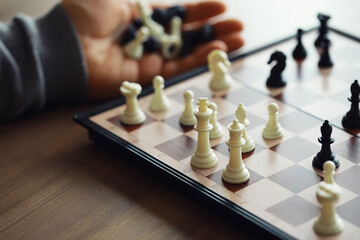 Hand playing game of chess, competition, strategy, battle, play