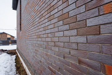 Close up shot of brickwork with snowcovered ground in the background