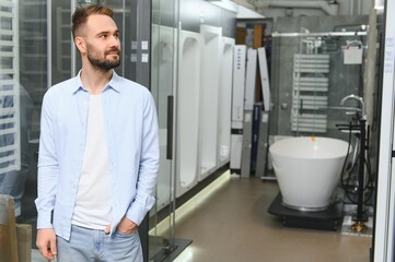 Young man choosing a bath and bath sink