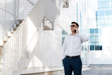 Man Talking on Cell Phone in Front of Building