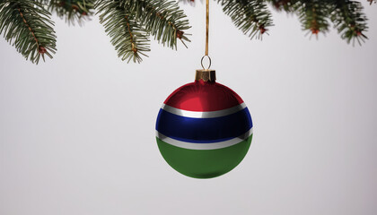 New Year's ball with the flag of Gambia on a Christmas tree branch isolated on white background. Christmas and New Year concept.