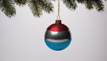 New Year's ball with the flag of Luxembourg on a Christmas tree branch isolated on white background. Christmas and New Year concept.