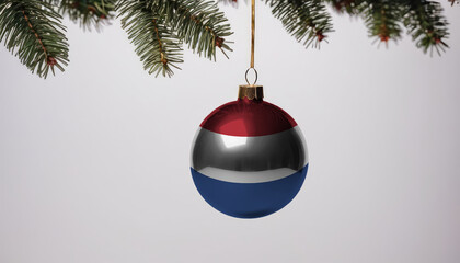 New Year's ball with the flag of Netherlands on a Christmas tree branch isolated on white background. Christmas and New Year concept.