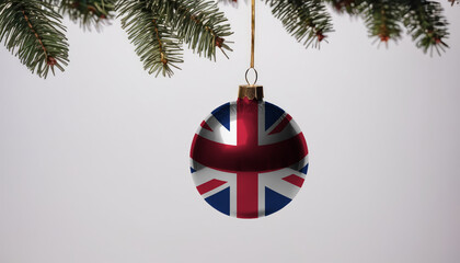 New Year's ball with the flag of United Kingdom on a Christmas tree branch isolated on white background. Christmas and New Year concept.